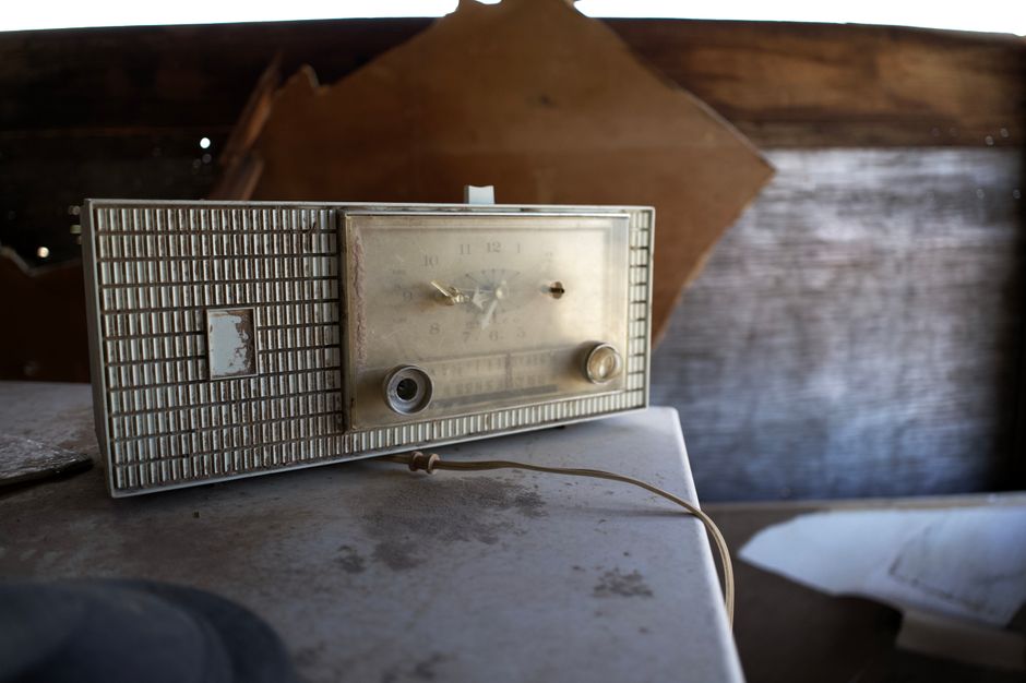 An old, dusty office with a vintage telephone and typewriter, symbolizing obsolete industries and outdated business fees being left behind.
